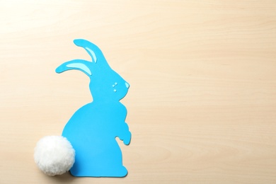 Photo of Flat lay composition of paper Easter bunny on wooden background, space for text