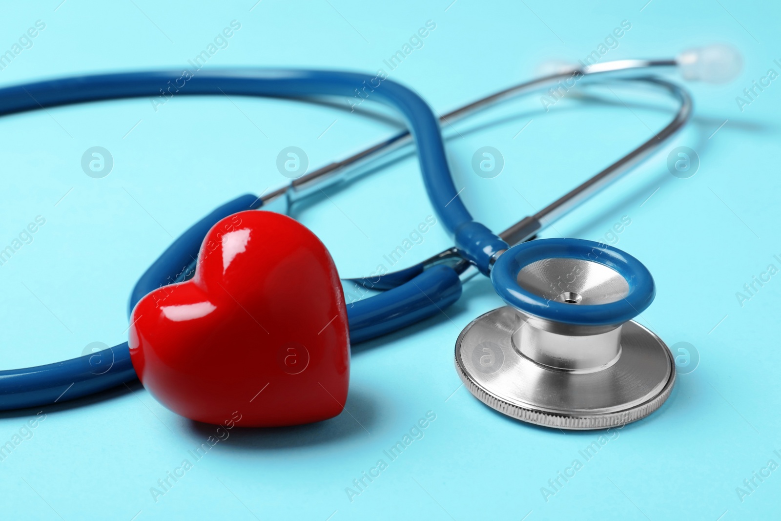 Photo of Stethoscope with red heart on blue background