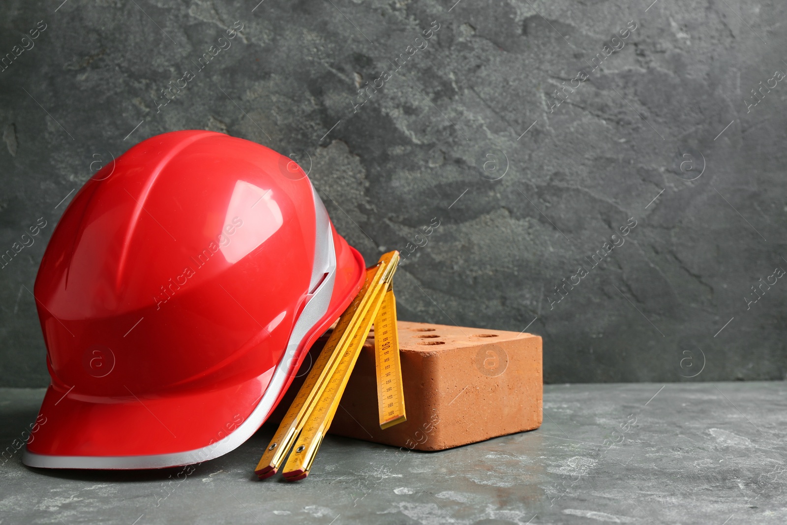 Photo of Composition with construction tools on grey table, space for text