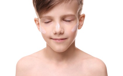 Boy with sun protection cream on his face against white background