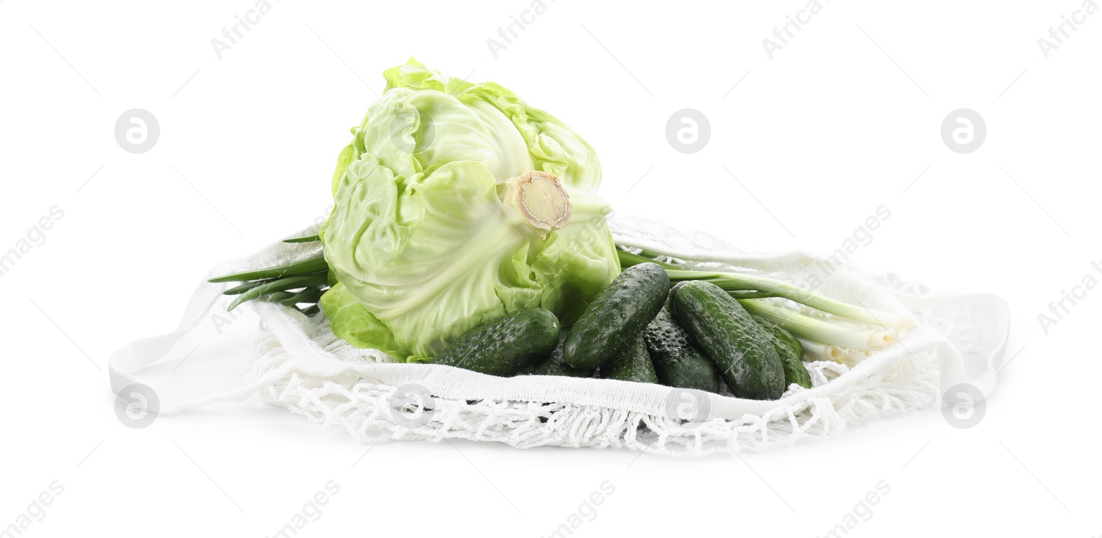 Photo of String bag with different vegetables isolated on white