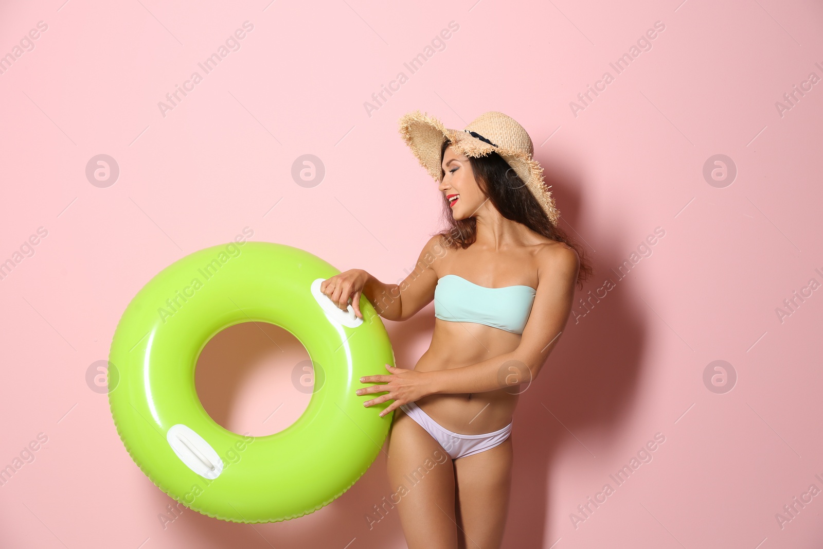 Photo of Beautiful young woman with inflatable ring on color background