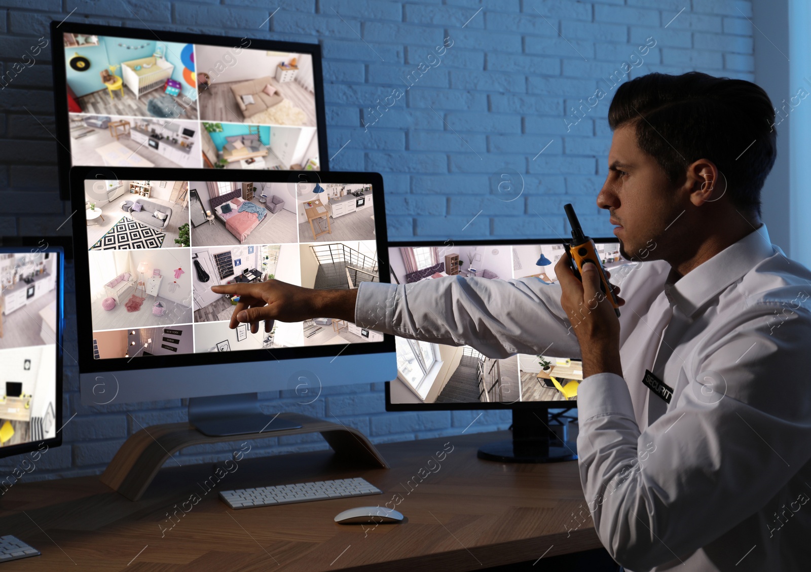 Photo of Male security guard with portable transmitter at workplace