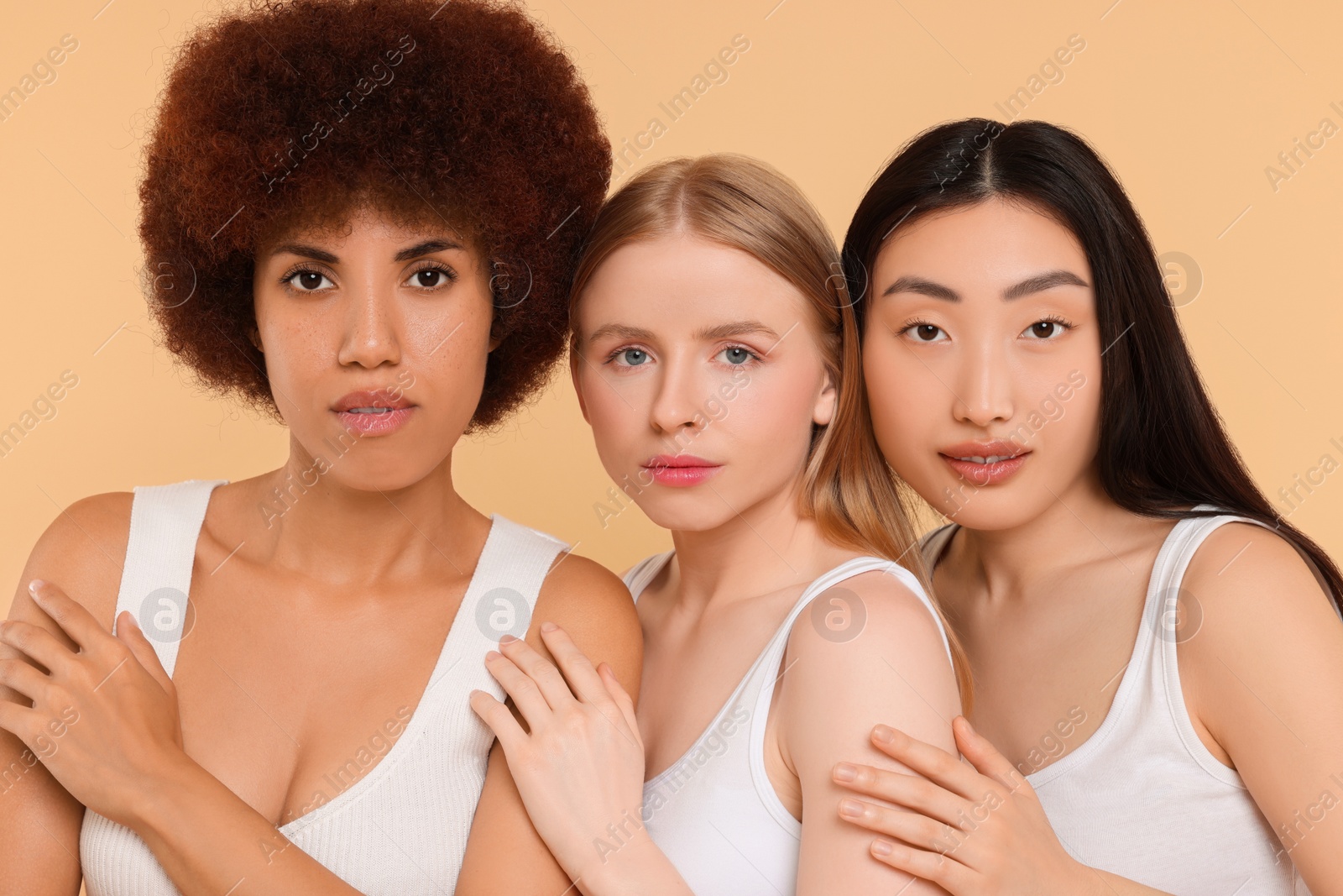 Photo of Portrait of beautiful young women on beige background