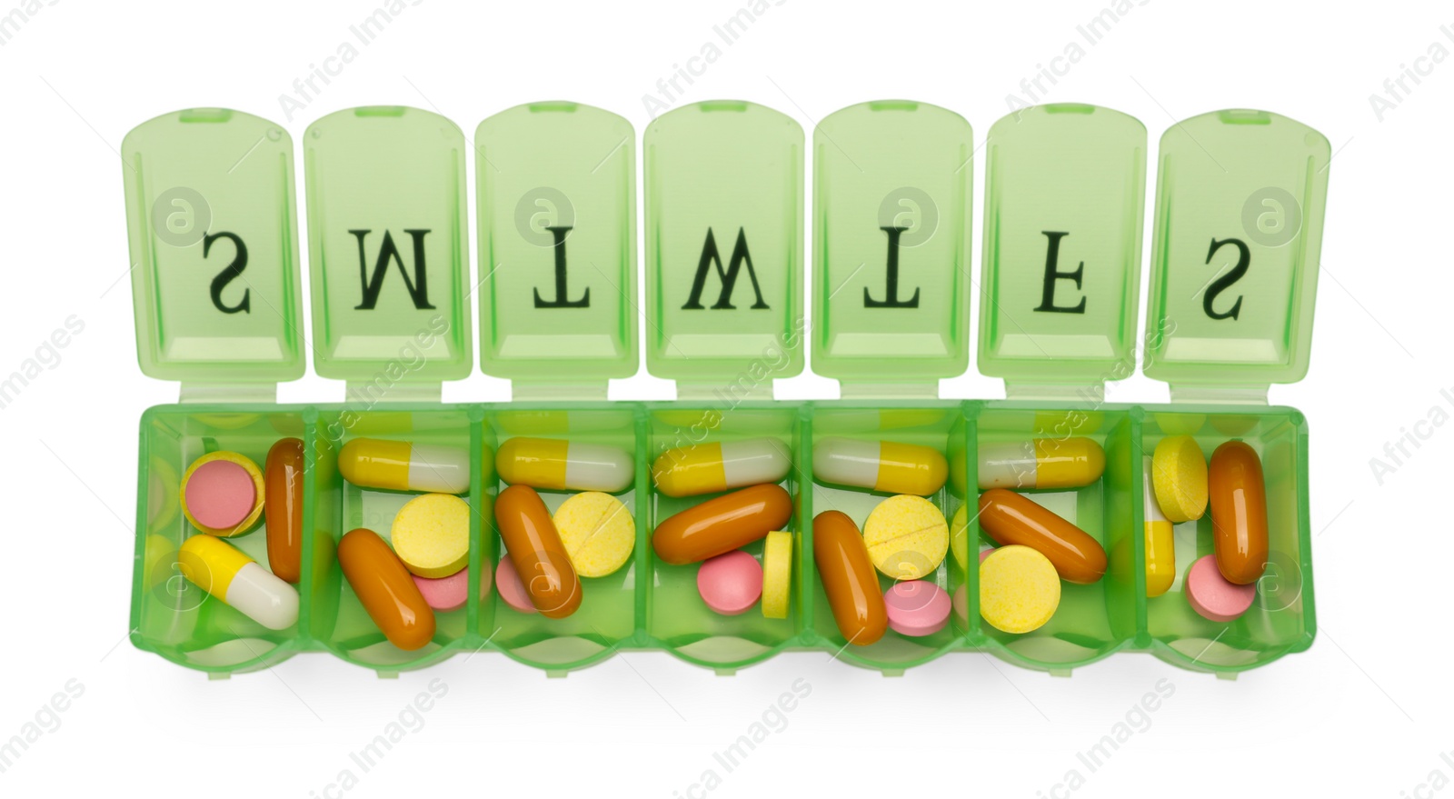 Photo of Different pills in organizer isolated on white, top view