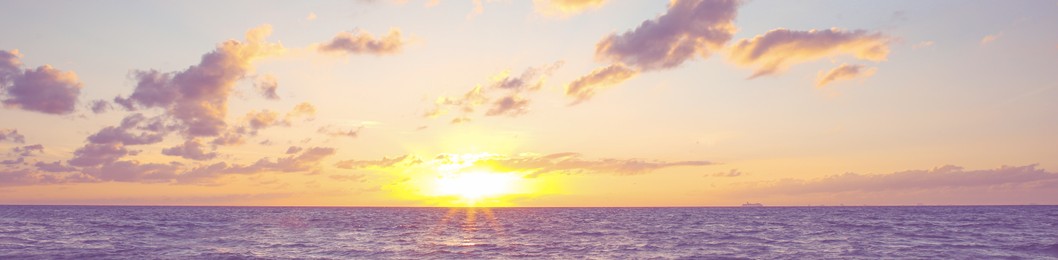 Image of Beautiful panorama of sky with clouds over sea at sunset. Banner design