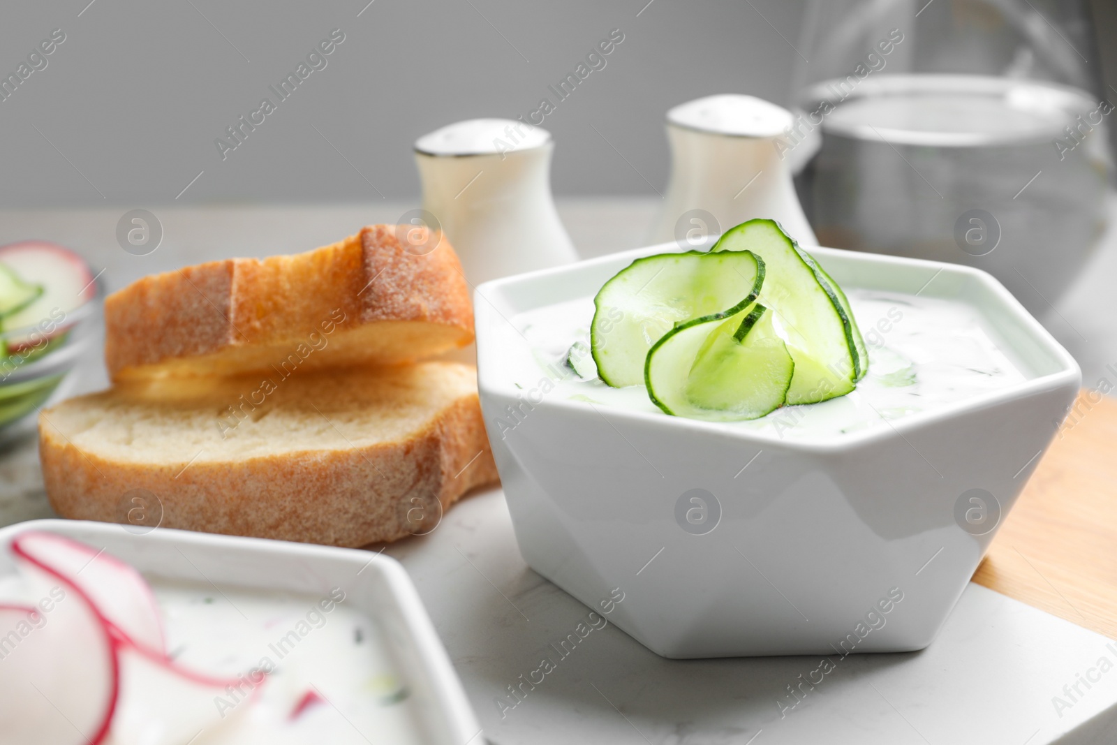 Photo of Delicious cold summer soup in bowl on table, closeup