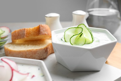 Delicious cold summer soup in bowl on table, closeup