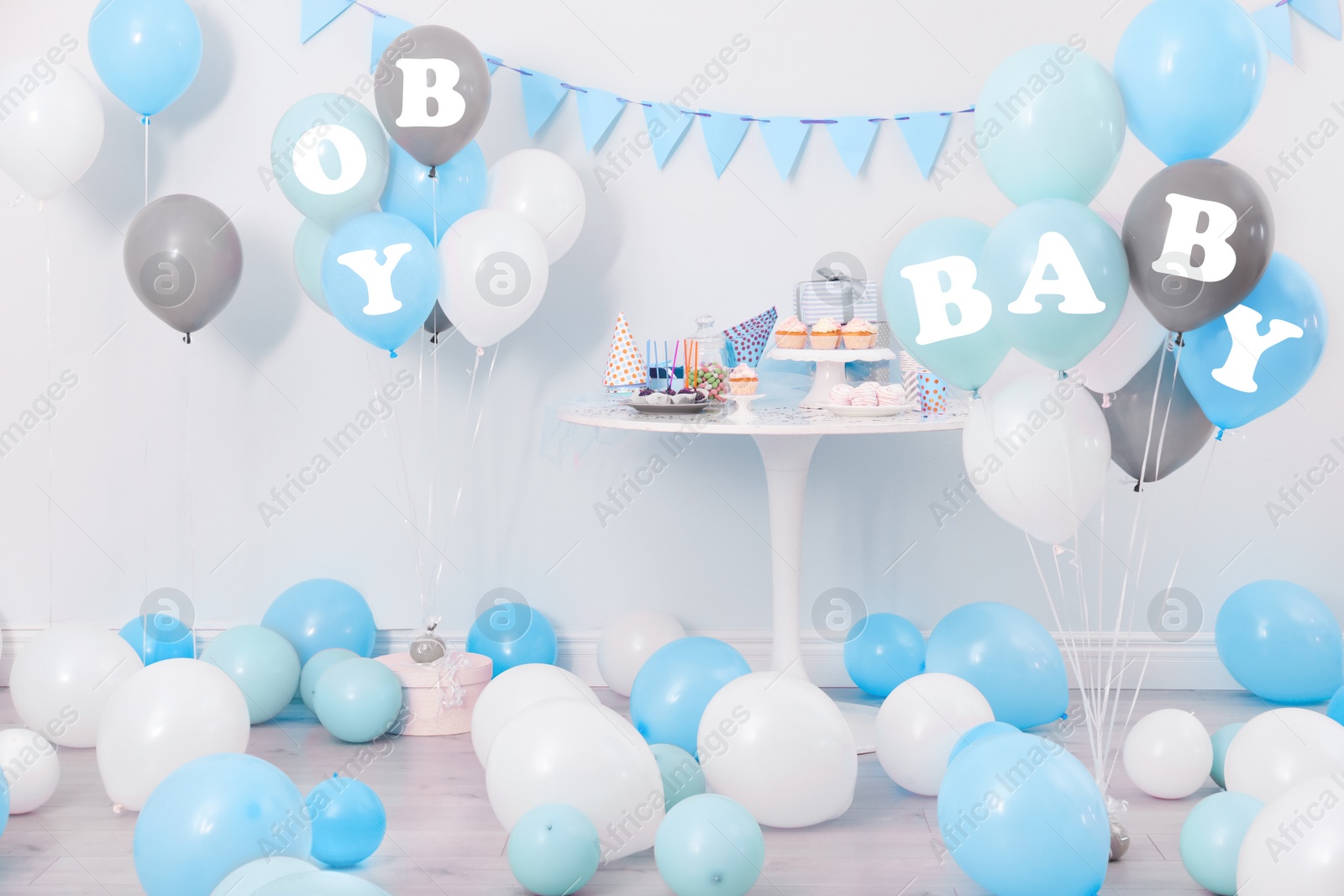 Image of Baby shower party for boy. Tasty treats in room decorated with balloons