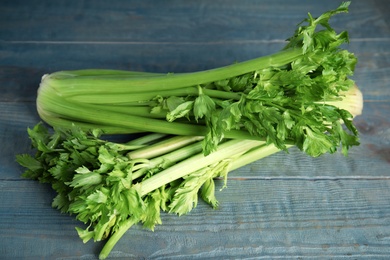 Fresh ripe celery on blue wooden table