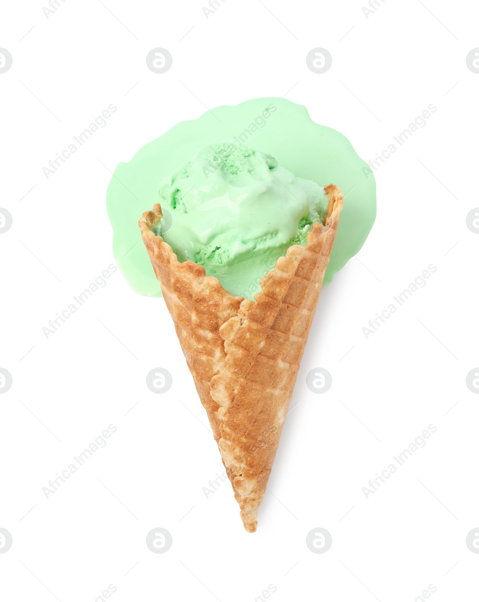 Photo of Melting ice cream in wafer cone isolated on white, top view