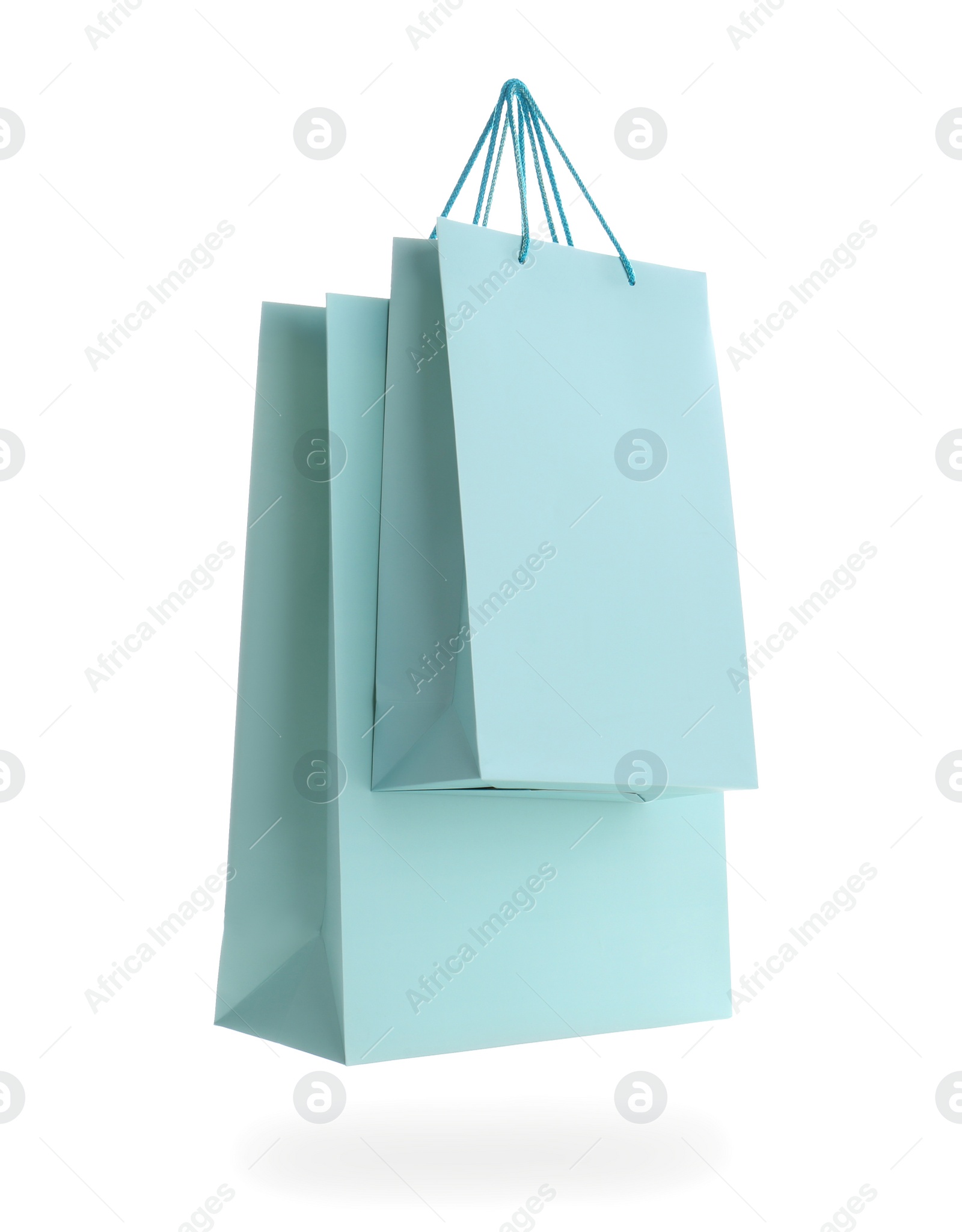 Photo of Light blue paper shopping bags isolated on white