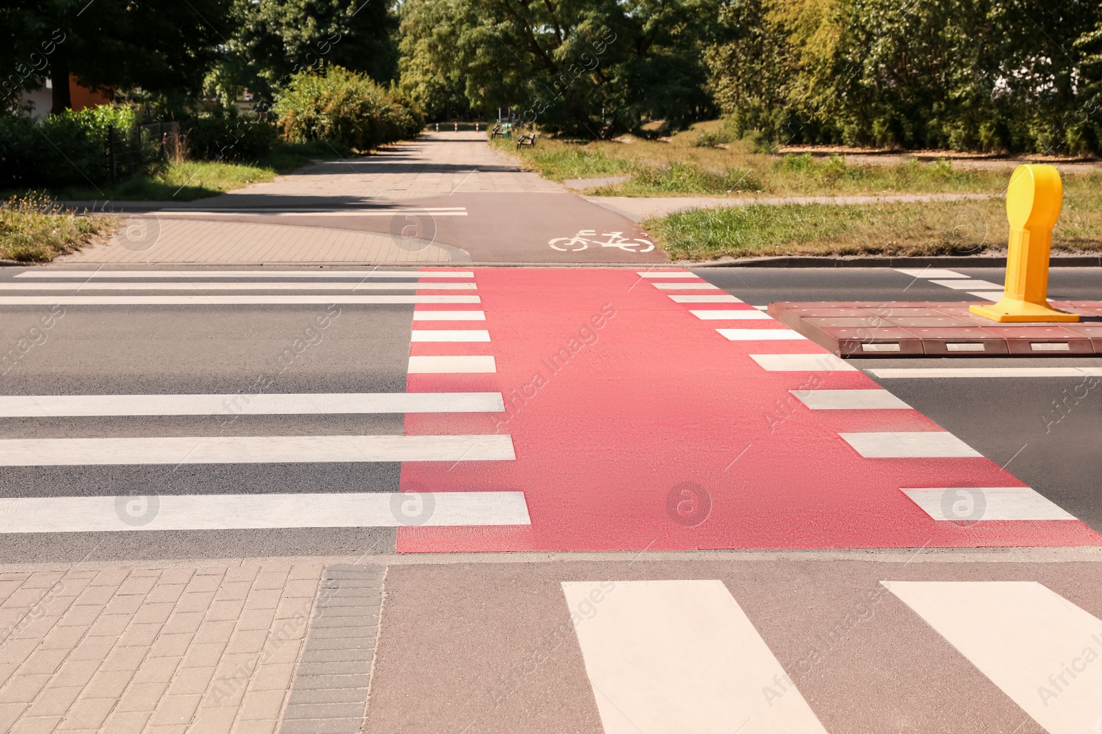 Photo of Bicycle lane with painted white sign and pedestrian crossing outdoors