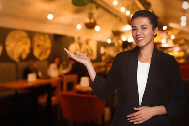 Image of Portrait of hostess wearing uniform in cafe. Space for text