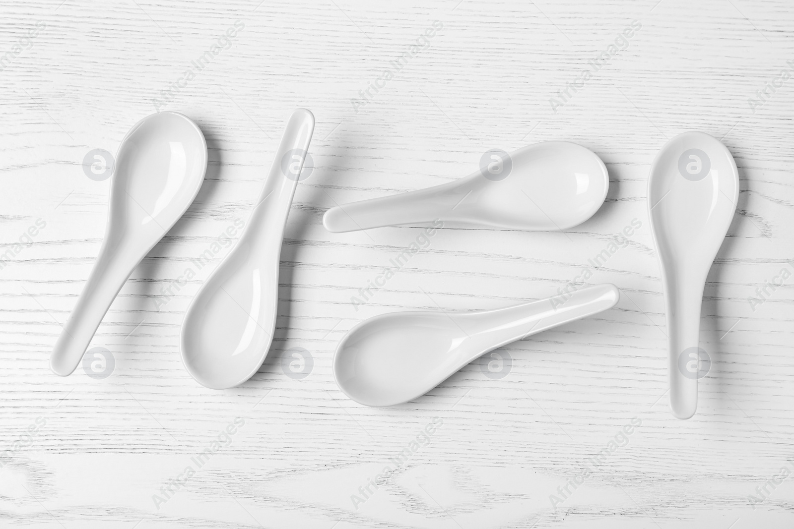 Photo of Flat lay composition with miso soup spoons on white wooden table