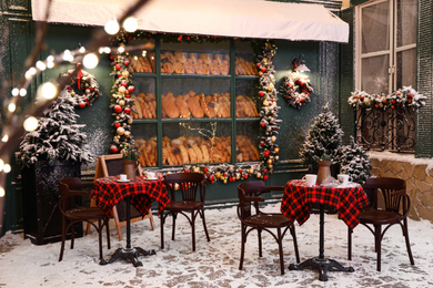 Photo of Beautiful outdoor cafe with festive decoration. Christmas celebration