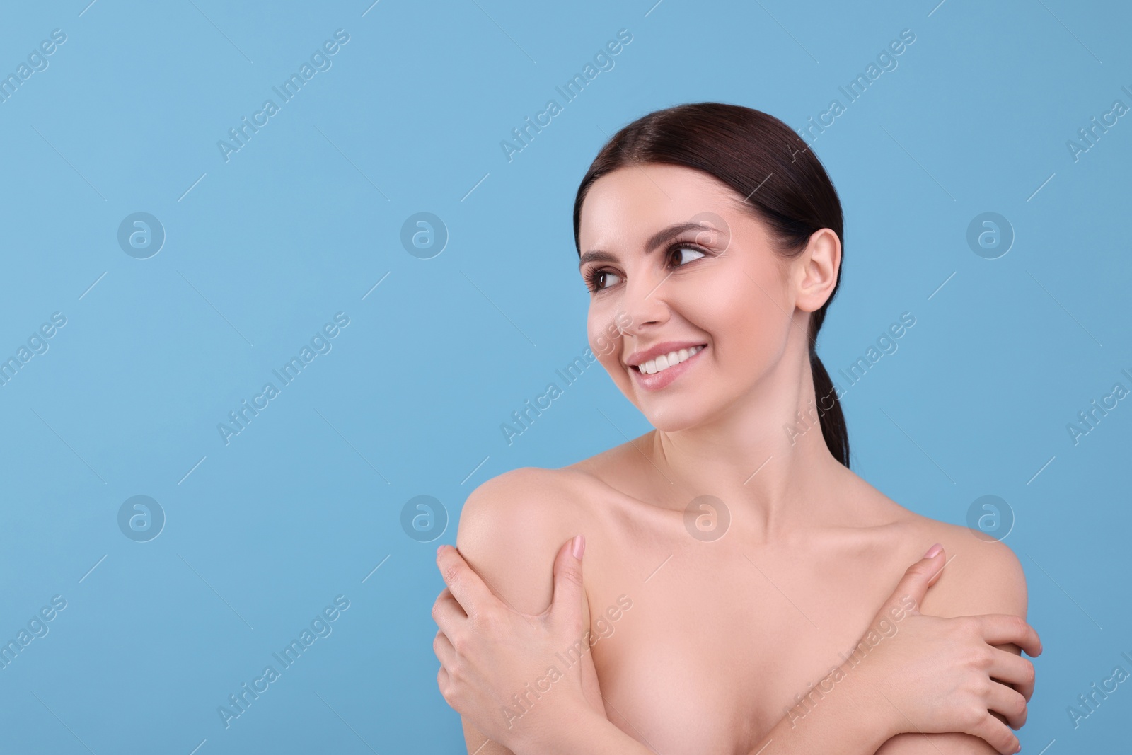 Photo of Beautiful woman with healthy skin on light blue background, space for text. Body Care