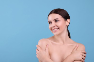 Photo of Beautiful woman with healthy skin on light blue background, space for text. Body Care