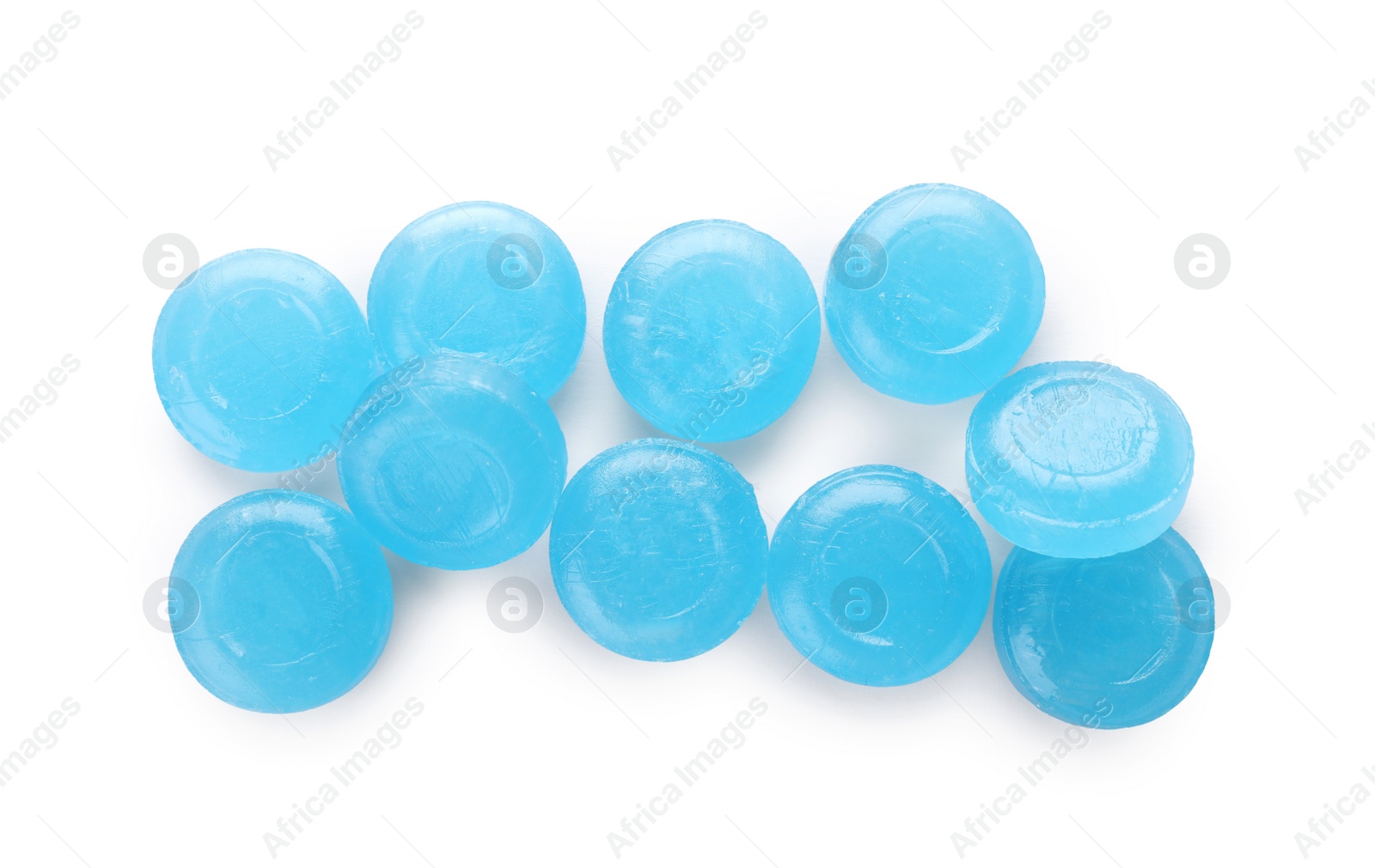 Photo of Many light blue cough drops on white background, top view