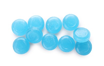 Many light blue cough drops on white background, top view