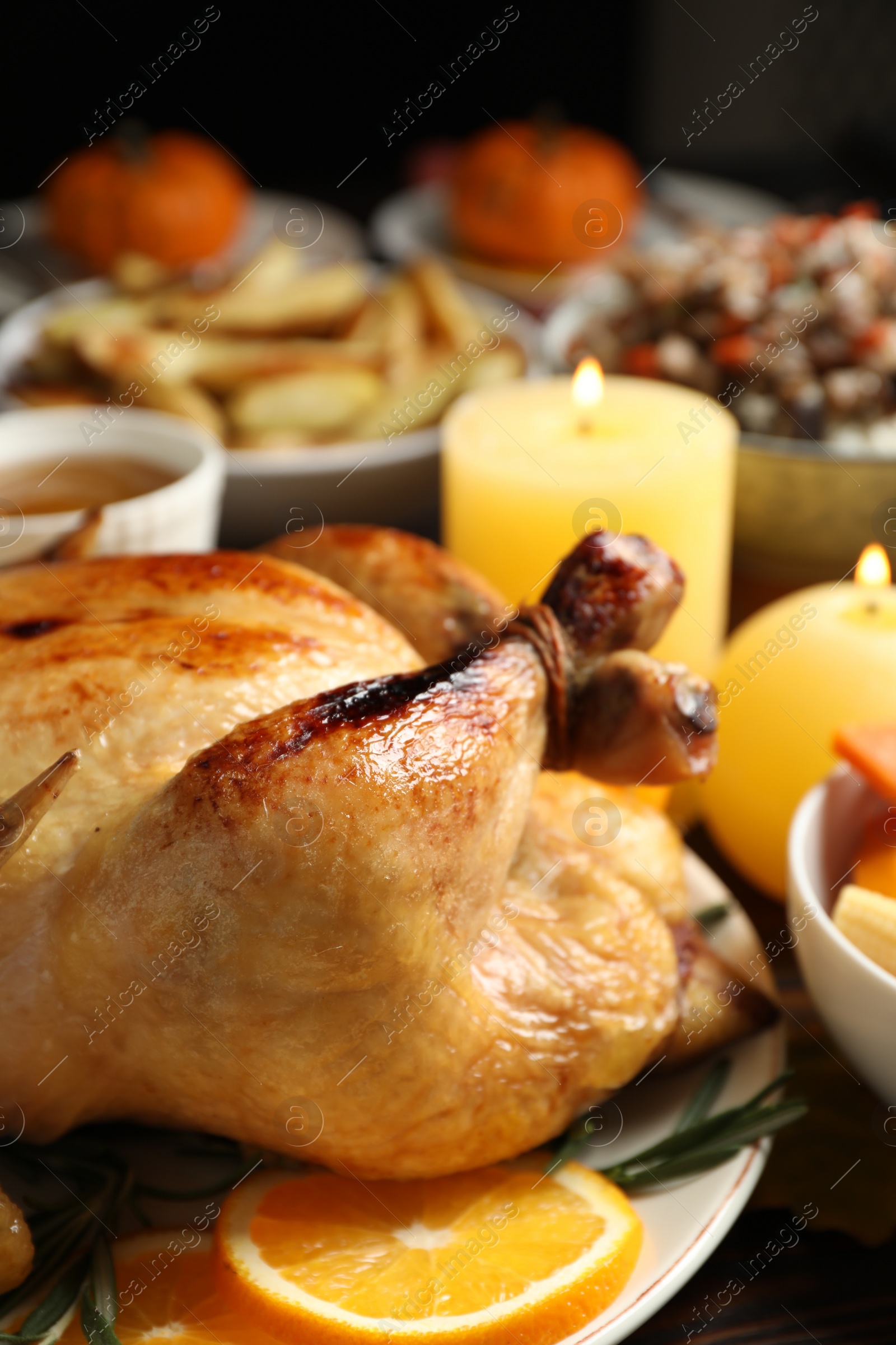 Photo of Traditional Thanksgiving day feast with delicious cooked turkey and other seasonal dishes served on table, closeup