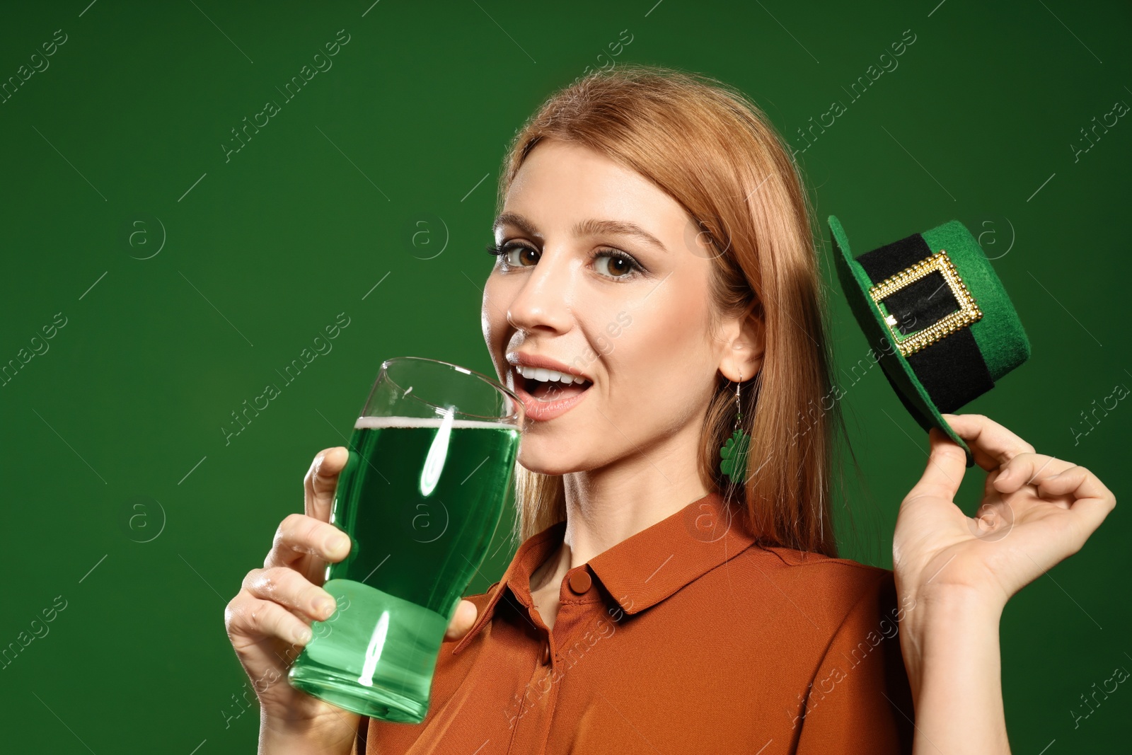 Photo of Young woman with green beer on color background. St. Patrick's Day celebration