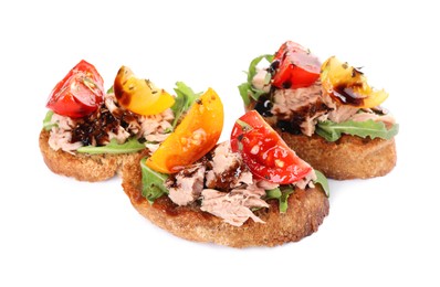 Delicious bruschettas with balsamic vinegar, tomatoes, arugula and tuna isolated on white