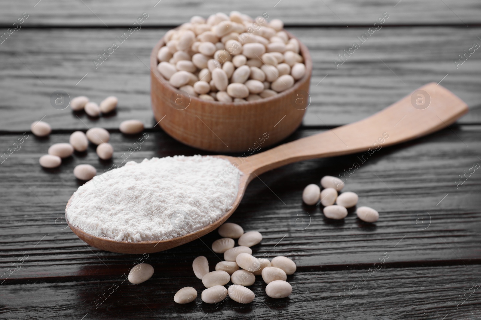 Kidney bean flour and seeds on wooden table, closeup Photo of Kidney bean flour and seeds on wooden table, closeup
