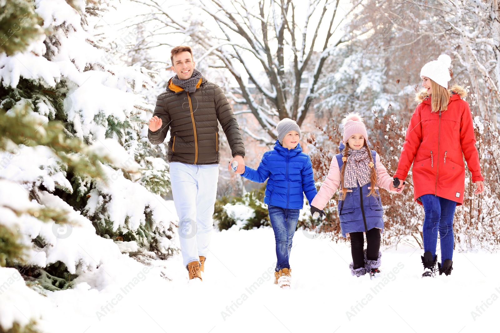 Photo of Happy family walking in winter park
