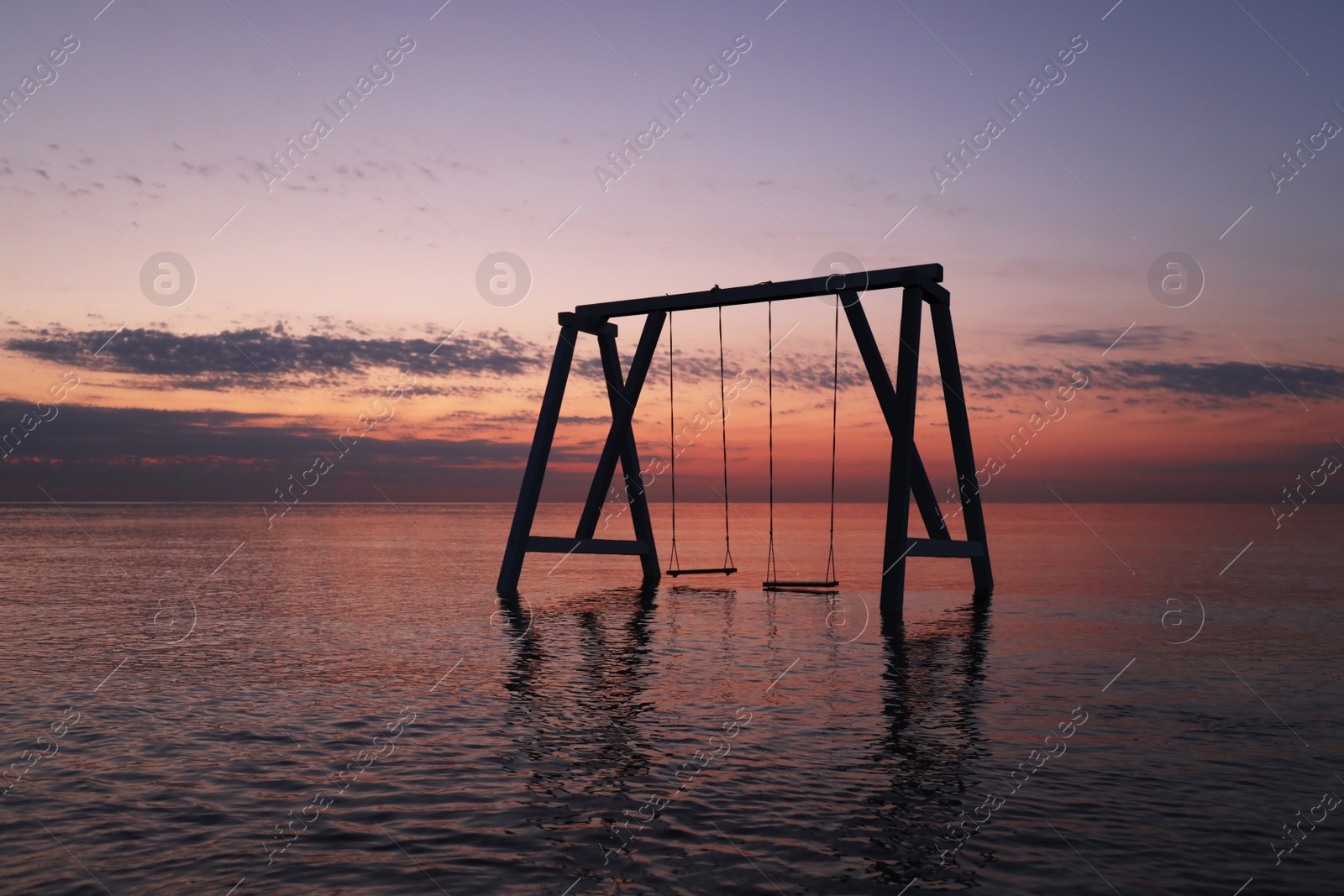 Photo of Picturesque view of swing in water on sunrise