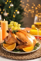 Photo of Delicious roasted turkey with garnish on dinner table