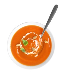 Bowl of tasty sweet potato soup with spoon isolated on white, top view