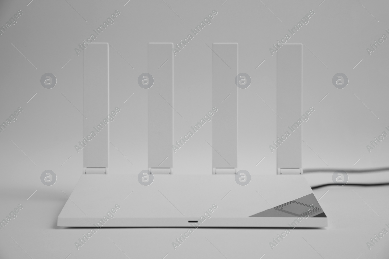 Photo of Modern Wi-Fi router on light grey background