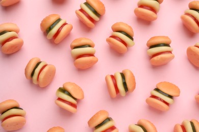 Photo of Tasty jelly candies in shapeburger on pink background, flat lay