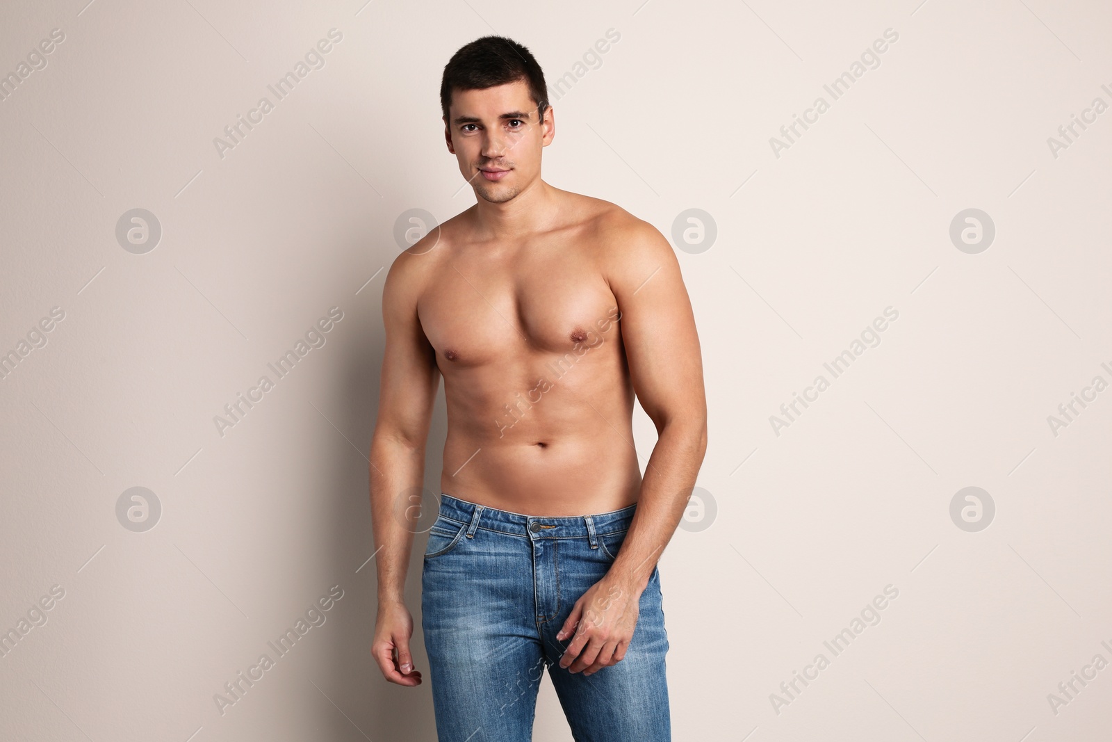 Photo of Man with sexy body on beige background