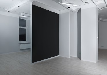 Photo of Empty renovated room with black and white walls