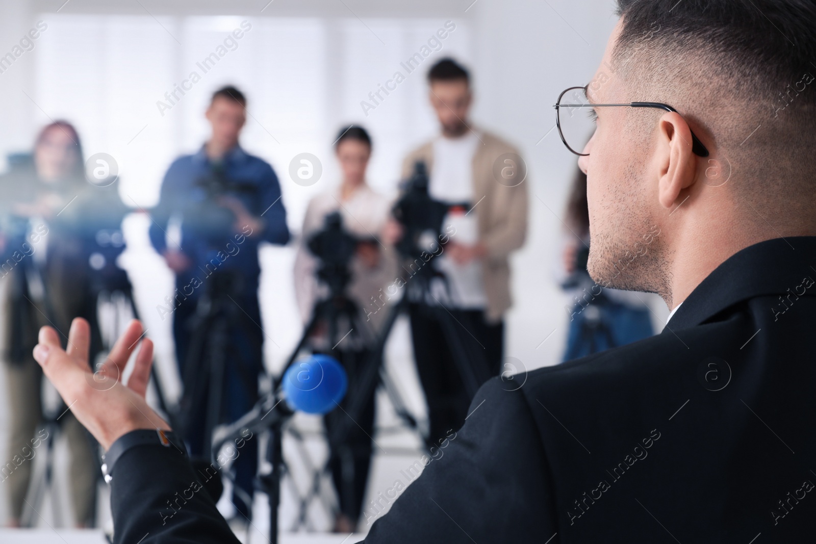 Photo of Businessman giving interview to journalists at official event, closeup