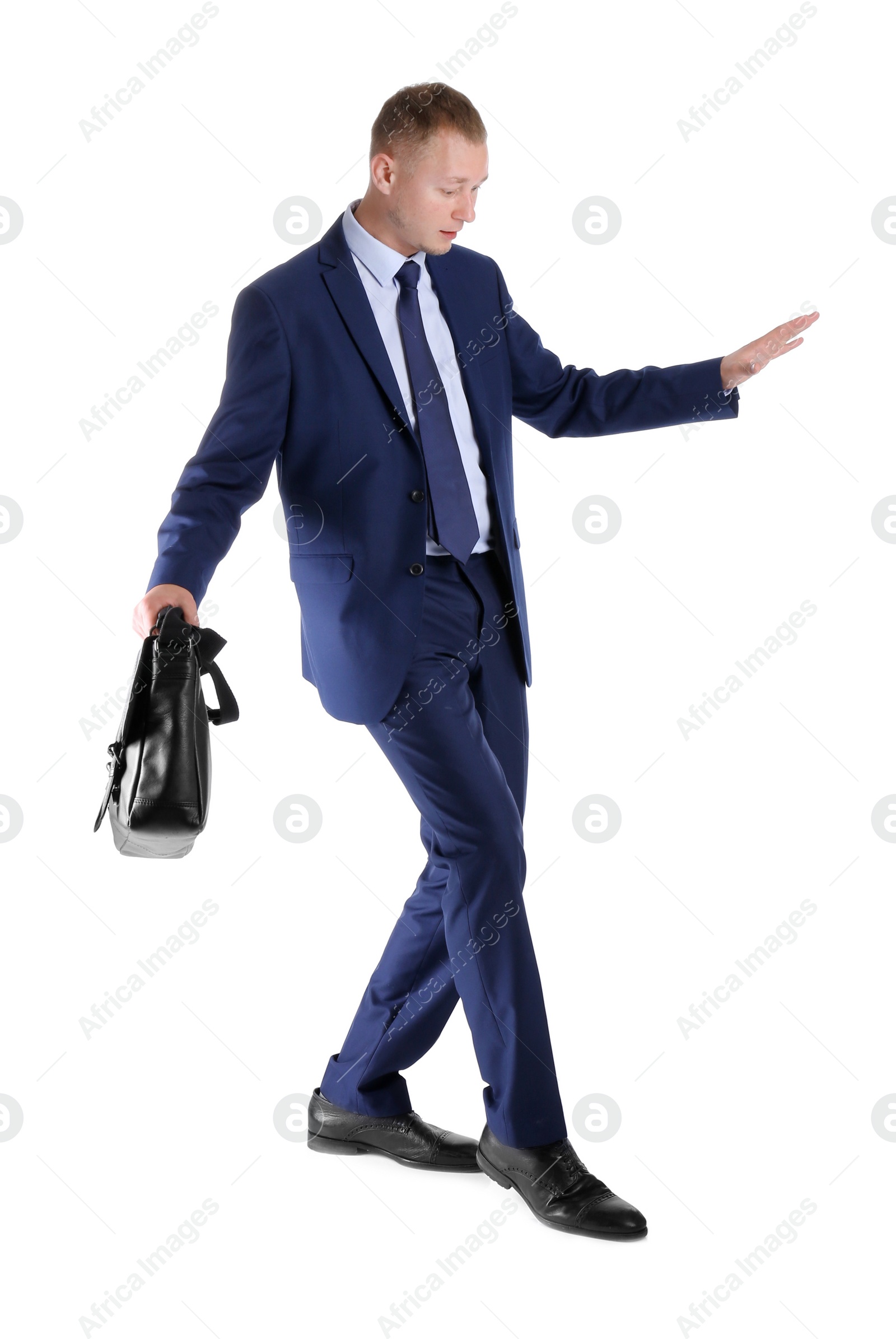 Photo of Businessman with briefcase balancing on white background