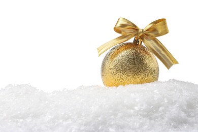 Photo of Beautiful golden Christmas ball with bow on snow against white background