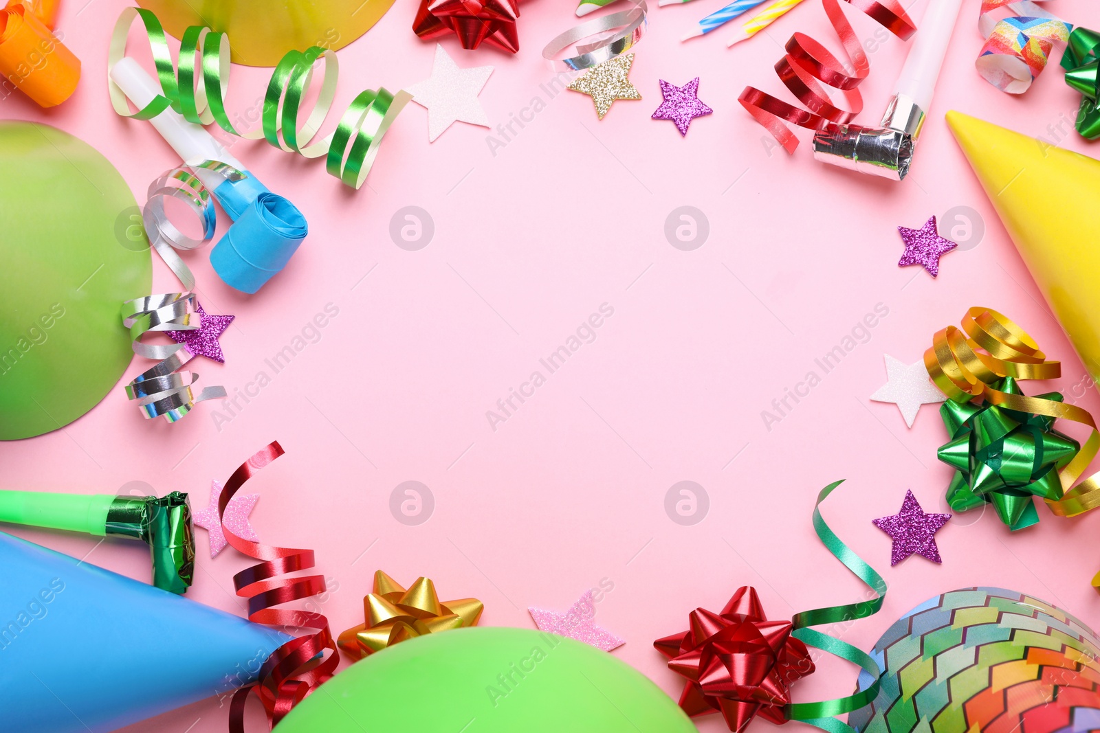 Photo of Frame of different accessories for birthday party on pink background, flat lay. Space for text