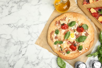 Delicious homemade pita pizza on white marble table, flat lay. Space for text