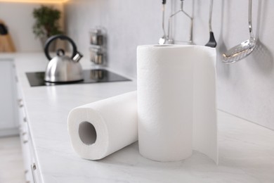 Photo of Rolls of paper towels on white countertop in kitchen