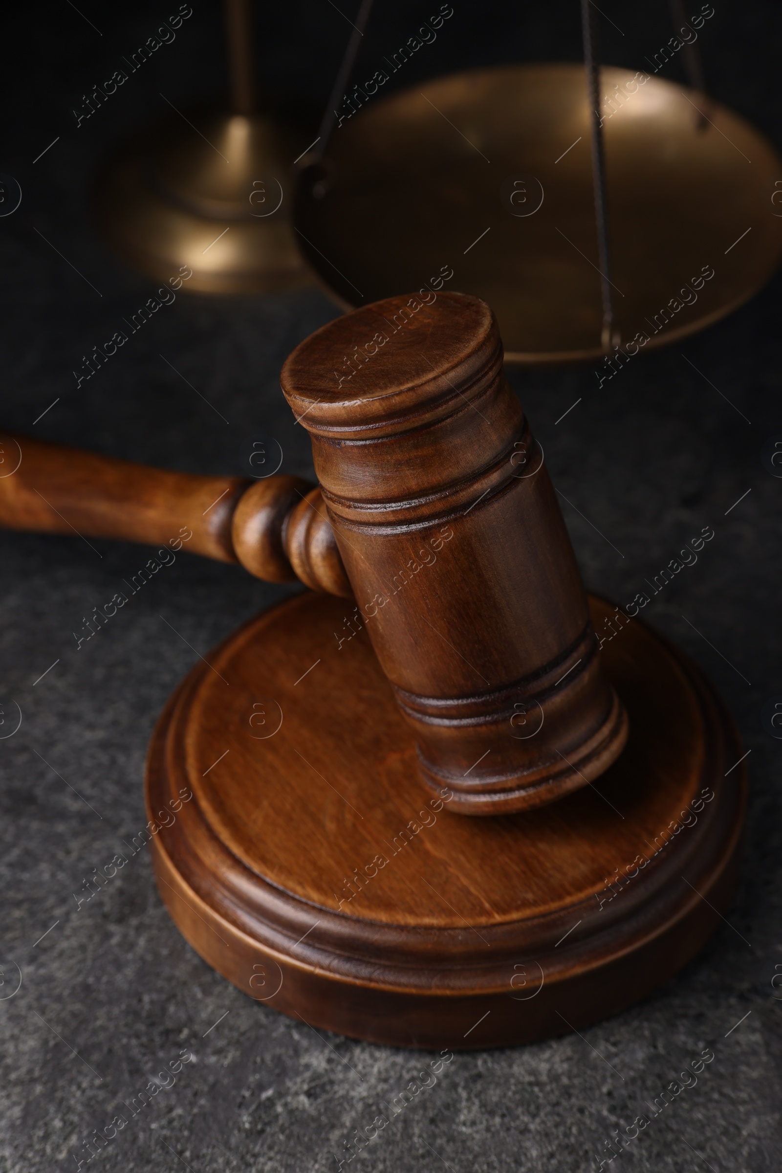 Photo of Law concept. Judge's wooden gavel on grey textured table