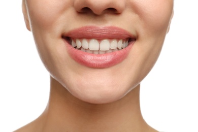 Woman with healthy teeth and beautiful smile on white background, closeup. Cosmetic dentistry