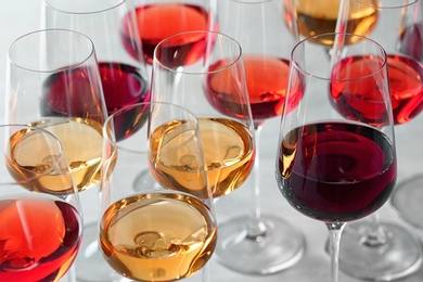 Photo of Group of glasses with different wines on light table