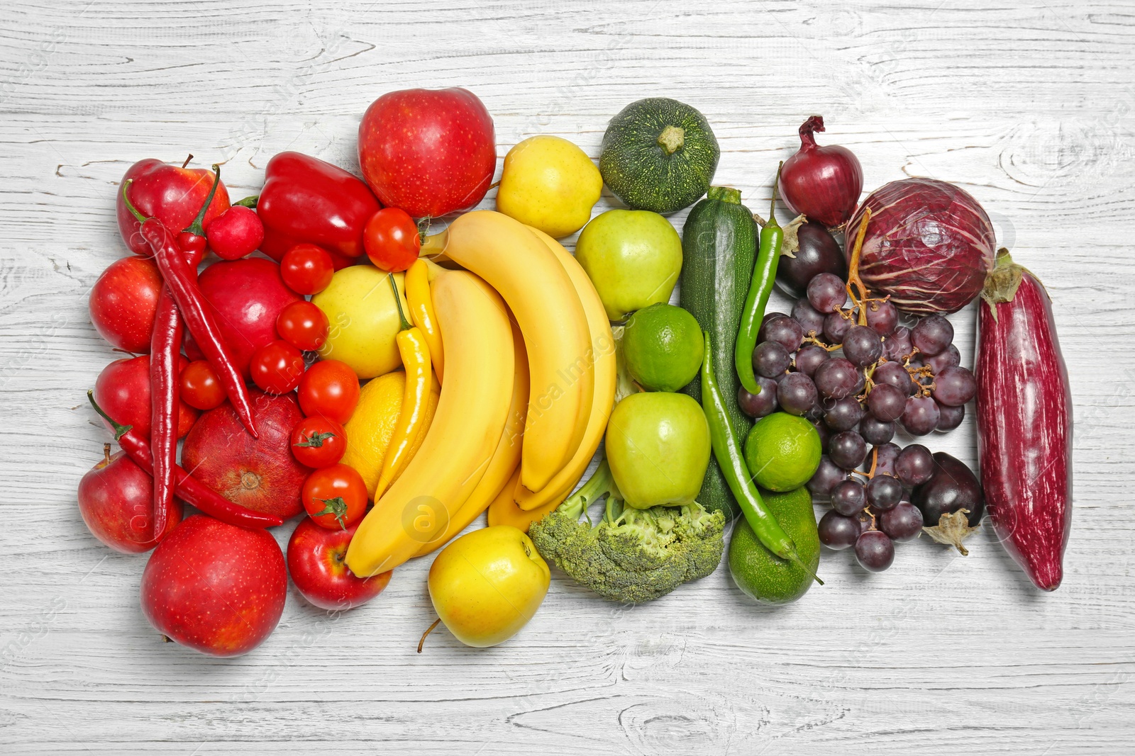 Photo of Rainbow composition with fresh vegetables and fruits on wooden background, flat lay