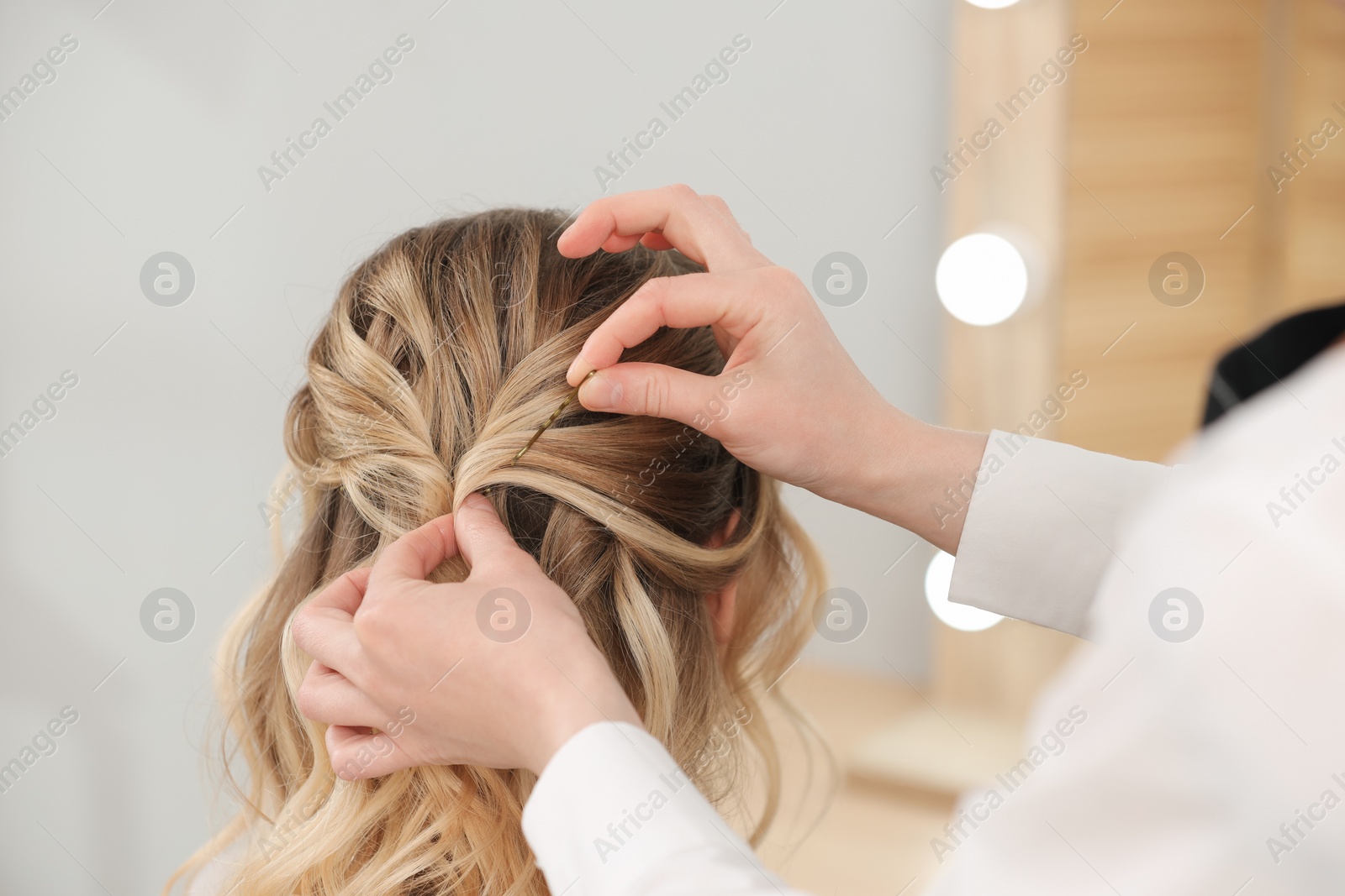 Photo of Hair styling. Professional hairdresser working with client in salon, closeup