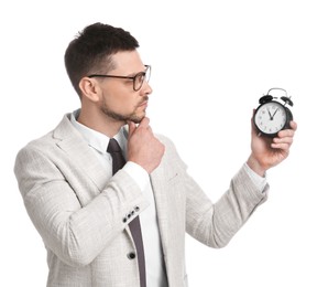 Photo of Businessman holding alarm clock on white background. Time management
