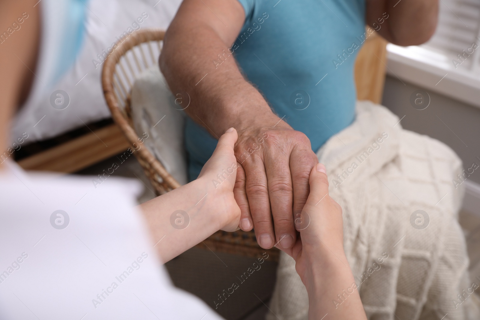 Photo of Doctor taking care of senior man at nursing home, closeup