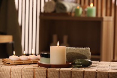 Beautiful composition with different spa products on wicker bench indoors